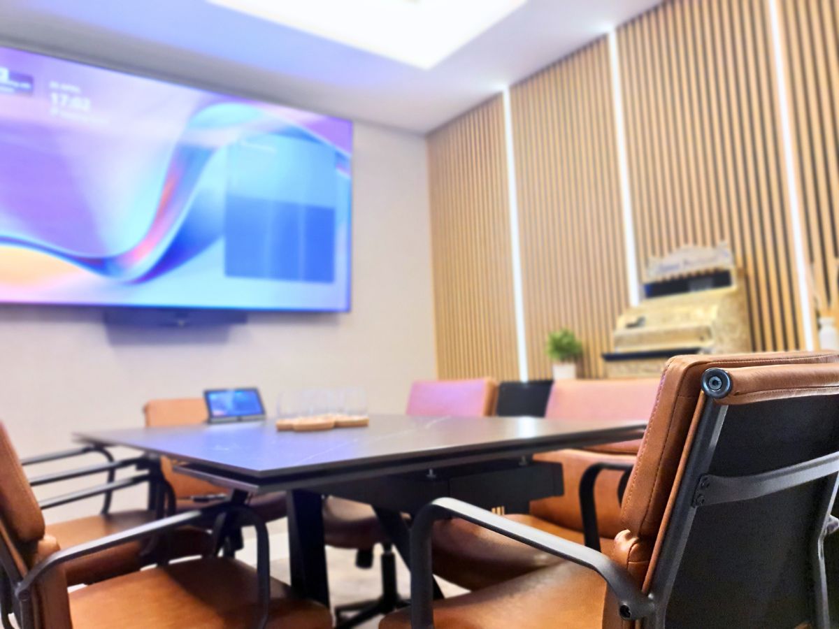 Modern boardroom meeting space with screen and seating in a professional Gibraltar IT services office