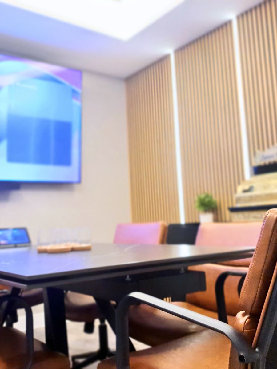 Modern boardroom meeting space with screen and seating in a professional Gibraltar IT services office